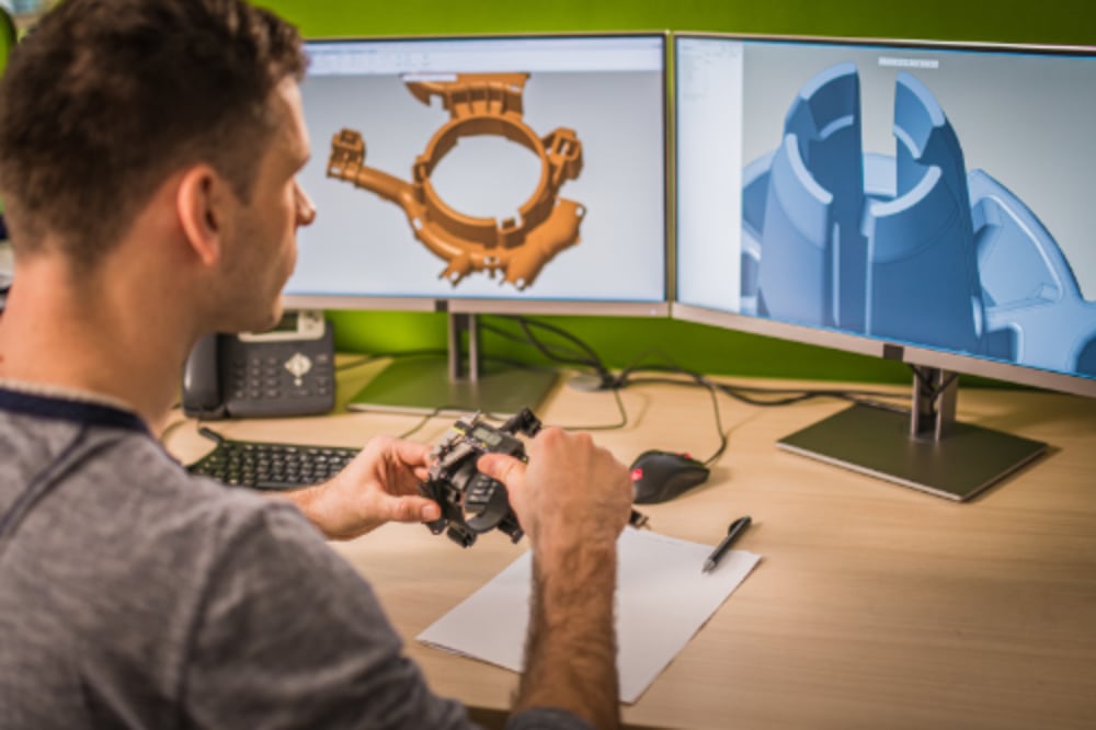 Man at a company desk using 3D modeling software for product development prototyping